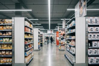 Agencement de rayonnages modulaires en grande surface par Someva, vue grand angle sur les allées d'un supermarché